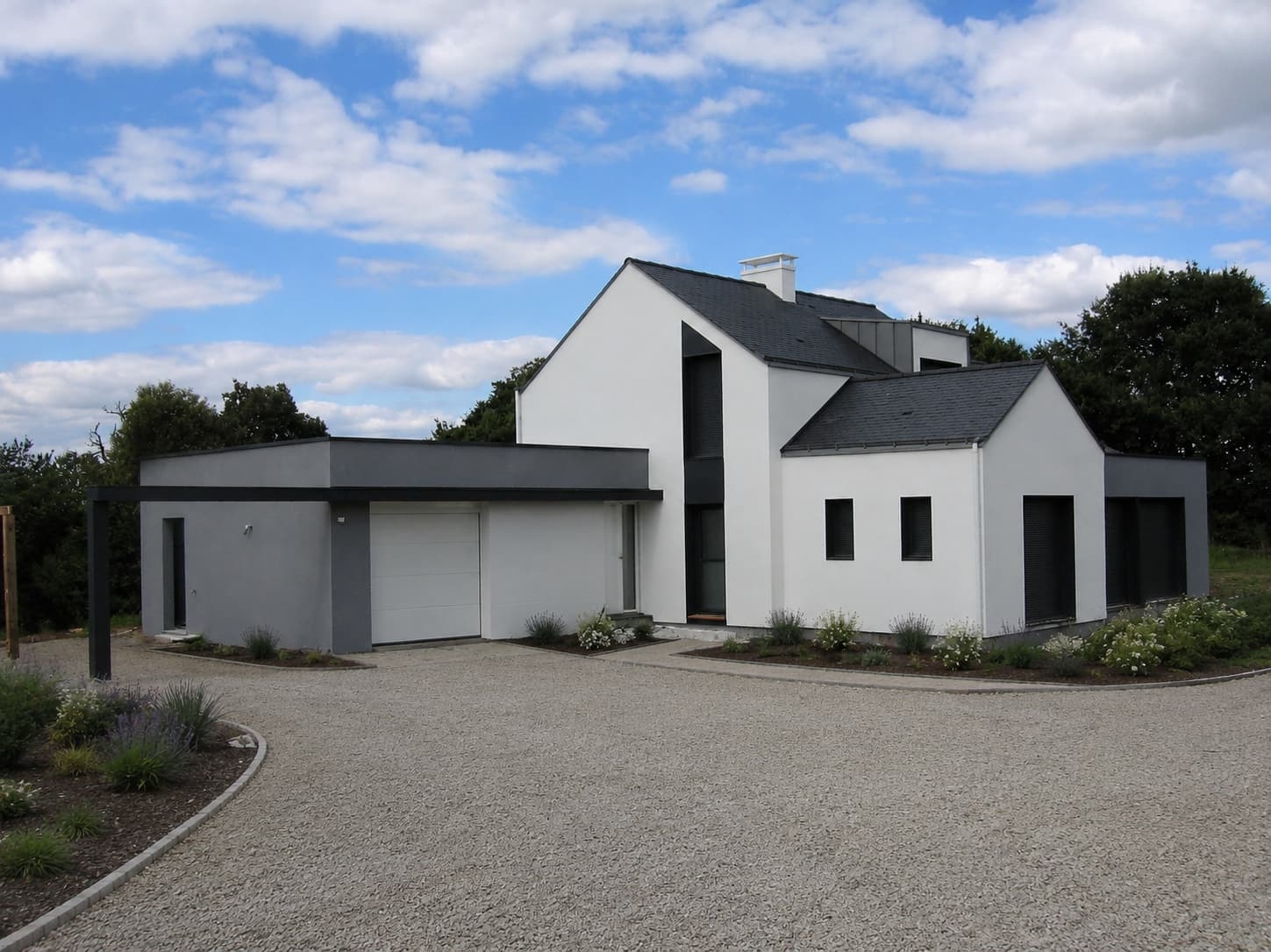 Maison en ossature bois avec un enduit blanc et une toiture en ardoise