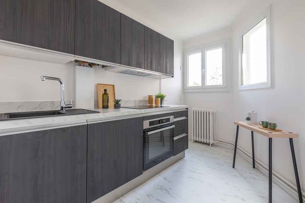 Cuisine accessoirisée apres home staging à Nantes Procé avec planche bouteille bocaux pates plante console vaisselle