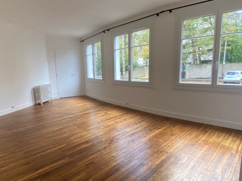 salon vide avec parquet, murs blancs, fenêtres sur rue avant home staging à Nantes Procé