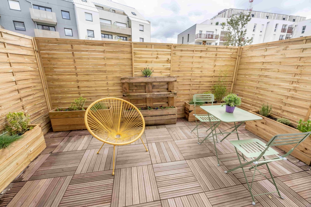Terrasse meublée et cloturée avec fauteuil table chaise après home staging à Nantes quartier Chalatres